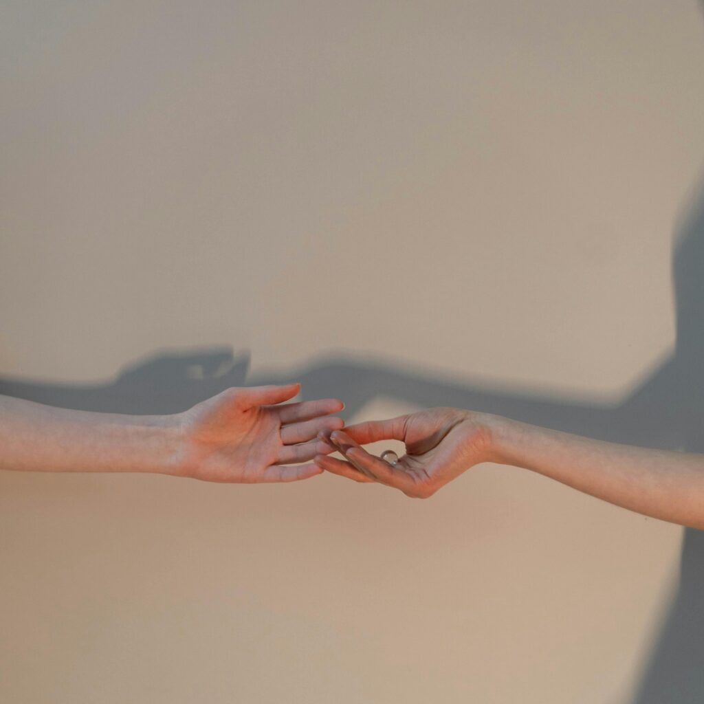 pexels-anastasia-shuraeva-6014182 two hands reaching for each other.